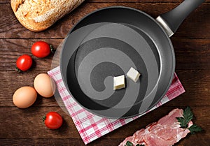 Ingredients frying pan bacon eggs bread tomatoes wooden background