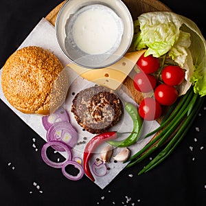 Ingredients for hamburger on a dark background. Top view.