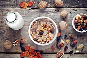 Ingredients for healthy breakfast: cereal wheat flakes and dried fruits