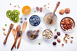 Ingredients for a healthy foods background, nuts, honey, berries