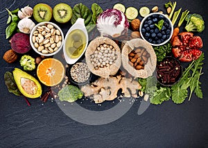 Ingredients for the healthy foods selection. The concept of healthy food set up on dark stone background