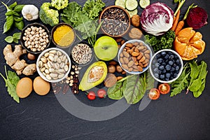 Ingredients for the healthy foods selection. The concept of healthy food set up on dark stone background