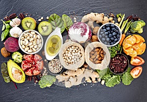 Ingredients for the healthy foods selection. The concept of healthy food set up on dark stone background