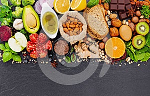 Ingredients for the healthy foods selection. The concept of healthy food set up on dark stone background