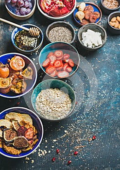 Ingredients for healthy vegetarian breakfast over dark blue plywood background