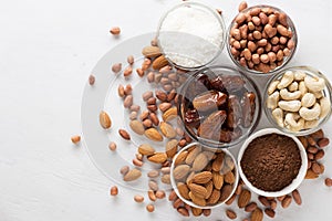 Ingredients for homemade no-bake brownie energy bites on white background.