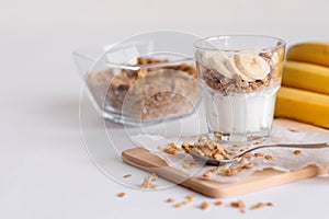 Ingredients for homemade oatmeal granola in glass jar. Oat flakes, honey, raisins and nuts. Healthy breakfast concept