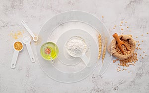 The ingredients for homemade pizza dough with wheat ears ,wheat flour and olive oil set up on white concrete background. top view