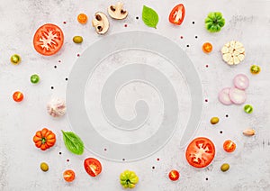 The ingredients for homemade pizza set up on white concrete background