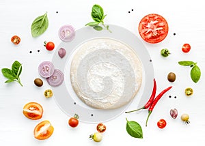 The ingredients for homemade pizza on white wooden background