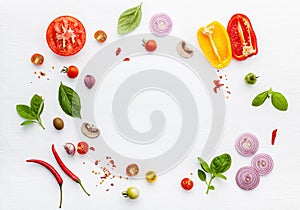 The ingredients for homemade pizza on white wooden background