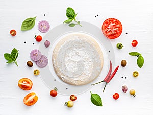The ingredients for homemade pizza on white wooden background