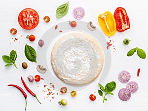 The ingredients for homemade pizza on white wooden background