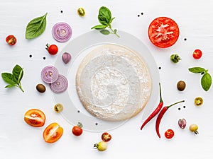 The ingredients for homemade pizza on white wooden background