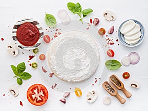 The ingredients for homemade pizza on wooden background