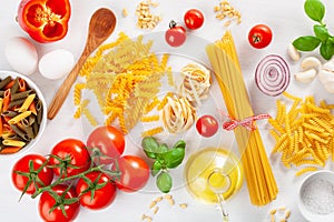 Ingredients for italian cousine flat lay, pasta spaghetti penne fusilli tomato oil vegetables