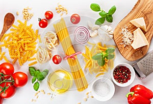 Ingredients for italian cousine flat lay, pasta spaghetti penne fusilli tomato oil vegetables