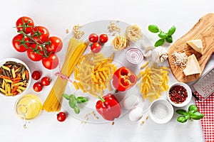 Ingredients for italian cousine flat lay, pasta spaghetti penne fusilli tomato oil vegetables