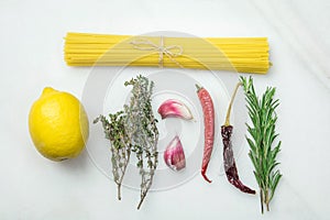 Ingredients for Italian Cuisine Pasta Dish. Food Knolling from Bundle of Spaghetti Lemon Thyme Rosemary Garlic Hot Chili Pepper