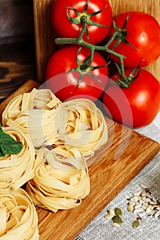 Ingredients for Italian Pasta on wooden table.