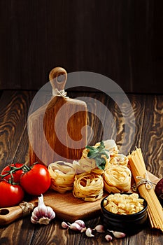 Ingredients for Italian Pasta on wooden table. Picture with free space for text.