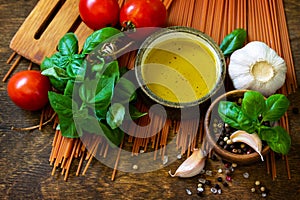 Ingredients for italy cuisine. Tomato spaghetti, herbs spices, olive oil and vegetables.