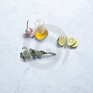 Ingredients from Italy, Isolated on Marble Background Ã¢â¬â Cut Slices of Lemon, Unpeeled Purple Garlic photo