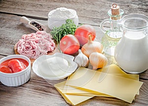 Ingredients for lasagne on the wooden background