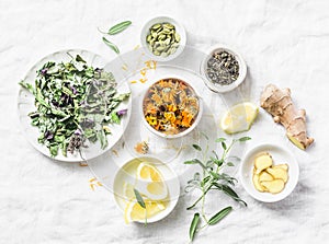 Ingredients for liver detox antioxidant tea on a light background, top view. Dry herbs, roots, flowers for homeopathy recipe for d photo