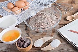 Ingredients for making cake chocolate with Notebook for recordin