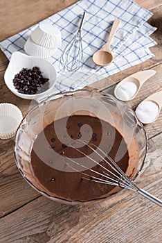 Ingredients for making cup cake chocolate on wooden background.