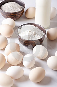 Ingredients for making dought.Eggs, flour and bottte of milk.Preparation for cooking bakery products