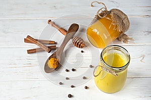 Ingredients for making a healthy drink of golden milk turmeric, honey, pepper and milk. Prevention of the virus