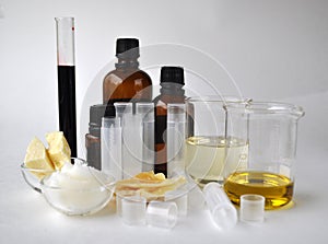 Ingredients for making natural cosmetics cacao butter, coconut, almond, jojoba and essential oils with tubes and bottles