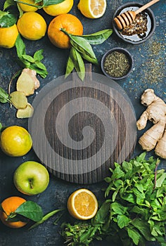 Ingredients for making natural drink, wooden round board in center