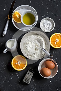Ingredients for making orange cake with olive oil - flour, eggs, olive oil, powdered sugar