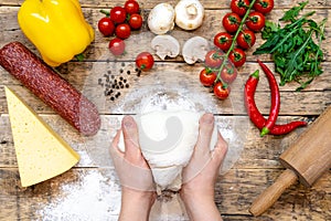 Ingredients for making pizza, before baking, on a wooden table, top view, step-by-step recipe
