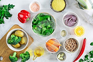 Ingredients for making a salad with baked vegetables, hummus and couscous. Top view