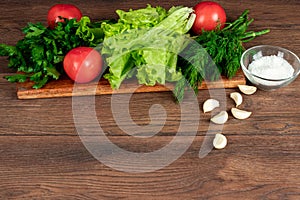 Ingredients for making salad, fresh vegetables on a wooden background