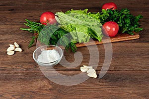 Ingredients for making salad, fresh vegetables on a wooden background