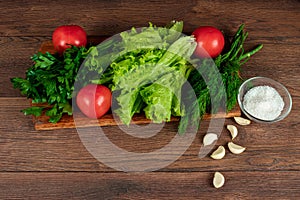 Ingredients for making salad, fresh vegetables on a wooden background