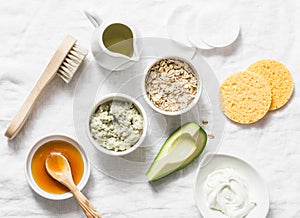 Ingredients for moisturizing, nourishing, anti-aging wrinkle face mask - avocado, olive oil, oatmeal, natural yogurt on light back photo