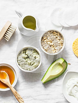 Ingredients for moisturizing, nourishing, anti-aging wrinkle face mask - avocado, olive oil, oatmeal, natural yogurt on light back