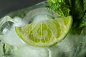 Ingredients of mojito cocktail: ice, mint and lime, close up