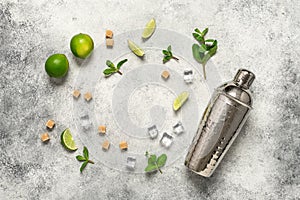 Ingredients for mojito frame, lime, mint leaves, shaker and cane sugar. Light gray vintage background. Top view, flat lay, copy