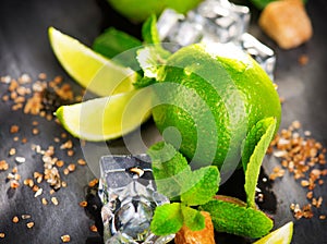 Ingredients of Mojito. Lime, mint, ice cubes and brown sugar