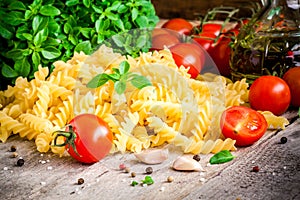 Ingredients for pasta: organic cherry tomatoes, fresh basil fusilli, garlic and olive oil