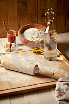 Ingredients for pizza dough flour with olive oil and yeast on wooden  table