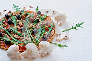 Ingredients for pizza - fresh mushrooms on the white table with free copy space on the right side. Vegetarian pizza