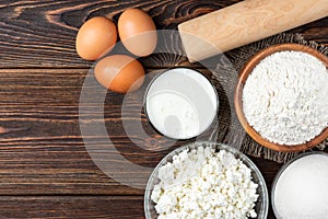 Ingredients for preparation cottage cheese pancakes. Cottage cheese, eggs, milk, sugar and flour